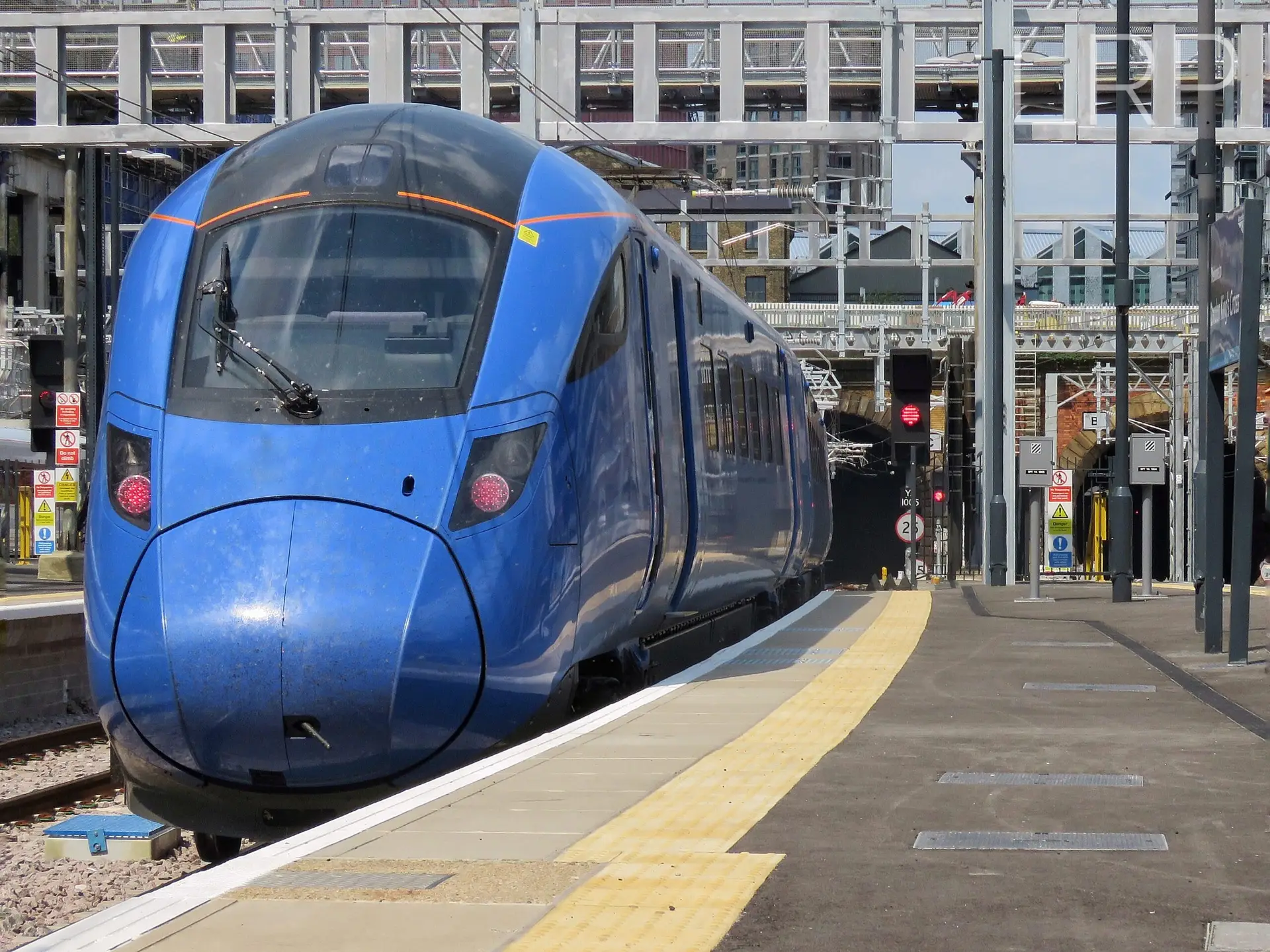 Lumo train departing Kings Cross. a blue train at a platform